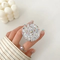 Glittery round collapsible phone socket with silver sequins held by a model - Silver Holographic Hexagon Style (16)