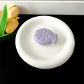 Detail of purple taiyaki fish-shaped phone grip on a round ceramic tray desk setup - Transparent Stand - Two-tone Fish / Purple