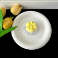 Macro detail of a cute yellow and white cat paw shaped phone grip stand on a white plate - Magnetic Stand / Yellow