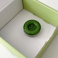 Detailed view of a glossy green button-shaped phone grip inside a matching gift box - Dark Green