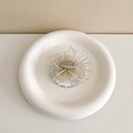 Macro detail of handmade floral sunburst phone grip with engraving on a gift card - English Firework-White