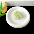 Detail of light green fish-shaped phone grip on a white circular gift base card - Magnetic Stand - Two-tone Fish / Dark Green
