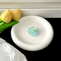 Close-up of a blue magnetic glitter bear phone socket holder on a white ceramic plate - Transparent Air Cushion Version / Green