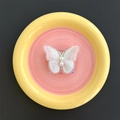 Close-up of pearl butterfly acrylic phone stand with delicate embroidery wings - Transparent Stand / White