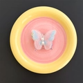 Detailed view of butterfly embroidery phone grip with gradient fabric and pearl accents - Transparent Stand / Pink
