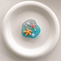 Detailed macro view of resin phone grip featuring blue ocean waves with starfish and pearls - Transparent Stand-Irregular Beach-Starfish