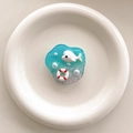 Detail of blue resin ocean phone grip with 3D whale and lifelike pearls on white plate - Transparent Stand-Irregular Beach-Dolphin
