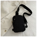 Detail of minimalist black nylon chest bag showing waterproof fabric and fashion label - Black
