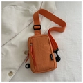 Detail of orange nylon chest bag with vertical zipper and fashion tag on striped background - Orange Red