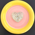 Macro detail of heart-shaped glitter phone grip with sequins and clear resin texture - Green
