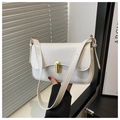 Detail of white rectangle shoulder bag featuring a gold bar twist lock and adjustable strap - White