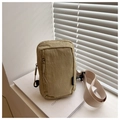 Detail of khaki nylon chest bag with fashion label and textured surface on a white background - Khaki