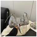 Detail of silver metallic shoulder bag with silver eyelets and adjustable buckle straps - Silver