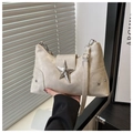 Detail of beige punk style shoulder bag with large silver star and metallic rivets - Beige