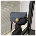 Close-up of black saddle bag with smooth PU finish and gold-tone square push lock - Black