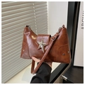 Detailed shot of brown PU leather shoulder bag with silver star rivets and buckle - Brown