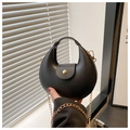 Detailed shot of a black crescent shoulder bag with golden chain and sleek matte finish - Black