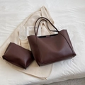 Dark brown matte leather tote bag and pouch set on a minimalist cream blazer background - Coffee