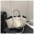 Close-up of minimalist off-white tote bag with black edge paint and dual straps - White