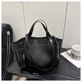 Detail of black tote bag featuring white contrast stitching and matte leather texture - Black