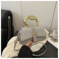 Detail of grey leather crossbody bag with silver sequins and unique gold metal handle - Silver