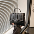 Elegant black crocodile-embossed handbag with metal chain strap and top handle design - Black