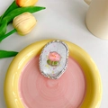 Detailansicht eines Tulpen-Handyhalters mit silbernem Glitzer und rosa Blumenmuster - Ovale eis-transparente Blume