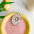 Detail of pink tulip bunny phone grip with glitter finish on a decorative ceramic tray - Oval Tulip Rabbit