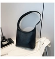 Detailed view of the black woven leather texture on a stylish large hobo bucket shoulder bag - Black