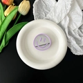 Detail of a purple smiley face mirror phone grip with a reflective surface in a white tray - Light Purple