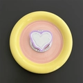 Detail view of pink heart MagSafe phone grip on a round ceramic vanity display tray - Light Purple