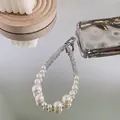 Elegant pearl and rhinestone phone wrist strap with silver lobster clasp on reflective surface - Pearl Rhinestone Chain + Transparent Patch