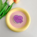 Detail of magnetic MagSafe heart phone stand with quote on yellow ceramic tray - Purple Text