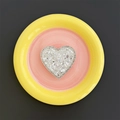 Macro detail of heart-shaped phone grip with glittering white rhinestones on pink tray - Silver
