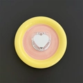 Detail shot of heart-shaped Magsafe phone mirror holder on a decorative ceramic dish - Iridescent Sequin