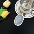 Close-up of silver oval phone socket with gray marble texture on black background - High-end Silver Grey Oval