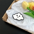 Close-up detail of a cute cloud-shaped mirror phone grip with a smiley face design - Black