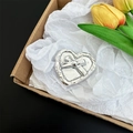 Macro detail of the silver heart-shaped phone grip featuring an elegant bow design - Heart Outline Glitter Cross Bow