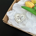 Close-up of a silver heart-shaped phone grip with a 3D metallic bow design accent - Heart Outline Glitter Bowtie