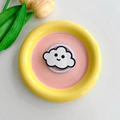 Macro detail of cute cloud accessory on macaron pink and yellow decorative mirror stand - Black