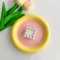 Detailed view of pearl square phone grip centerpiece with gold metal base and ivory beads - Off White