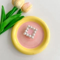 Close-up of square pink pearl phone grip on floral ceramic plate with tulip - Pink