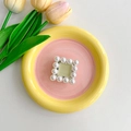 Square phone grip with cream pearl trim and sage green inlay on a decorative tray - Green