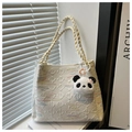 Detail of white embossed bucket bag with braided strap and cute panda charm accessory - White With Pendant