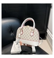 Detail of shell-shaped crossbody bag featuring beige monogram pattern and red trim - White