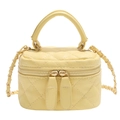Quilted yellow mini square crossbody bag with gold chain strap and top handle on white background - Yellow