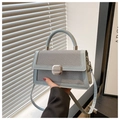 Detail of light blue crossbody bag with woven texture and silver square buckle closure - Blue