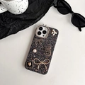 Detail of luxury iPhone case featuring glitter, rhinestones, pearls and golden charms - iPhone 7/8/SE 2020 / Black (Number 5 Bowknot)