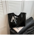 Detail of black patent tote bag featuring elegant lace and pearl bow charm accessory - Without Pendant / Black