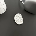 Makrodetail der ovalen silbernen Handyhalterung mit weißem Emaille- und Schleifenrelief - Transparenter Halter - Oval Glitzer - Silberperle Schleife